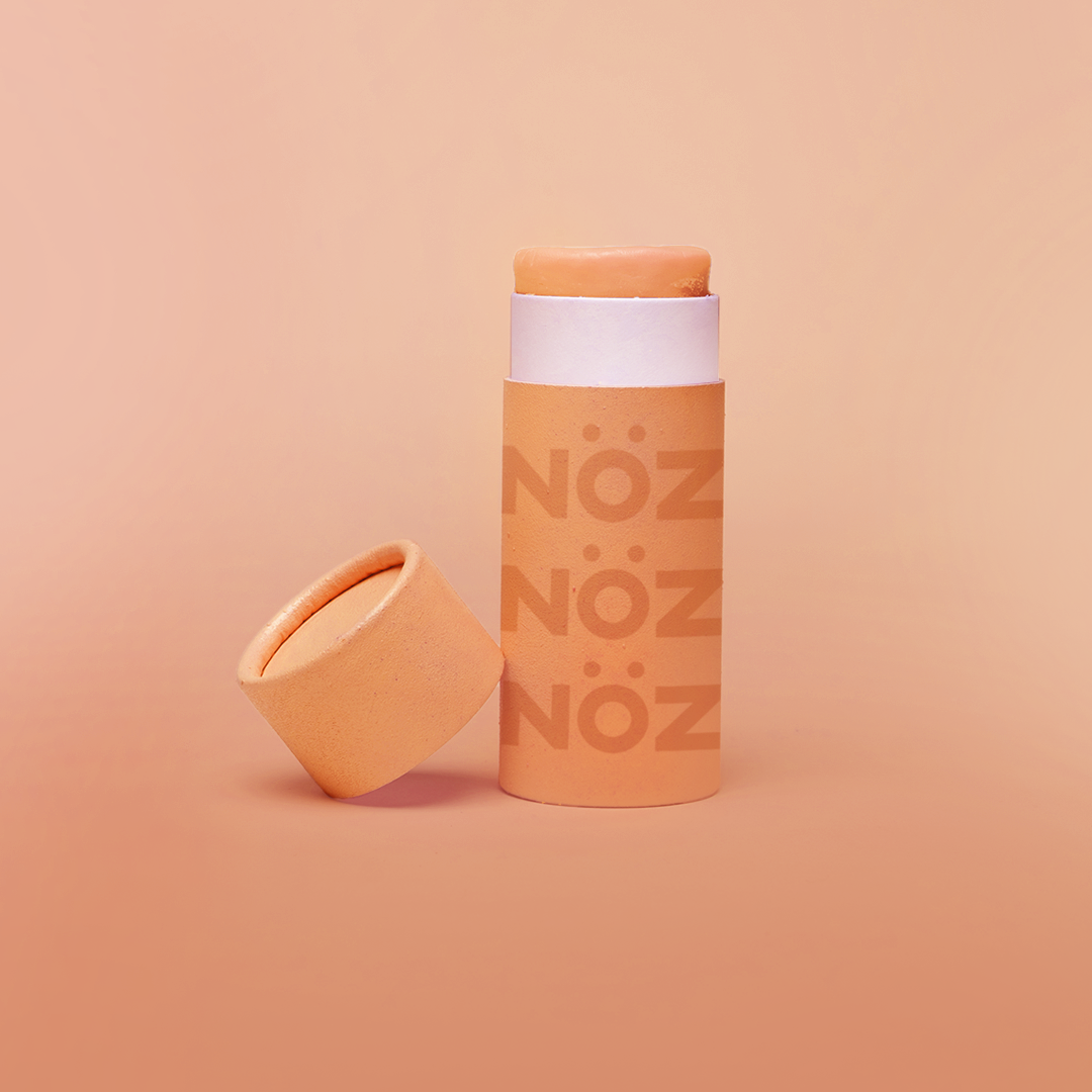 Orange cardboard container of NöZ reef safe sunscreen.