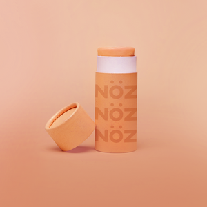 Orange cardboard container of NöZ reef safe sunscreen.